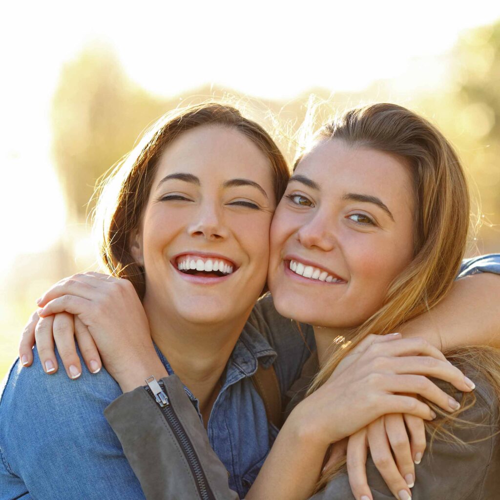 burckhard-ortho-hero-square-friends-hug-smiling