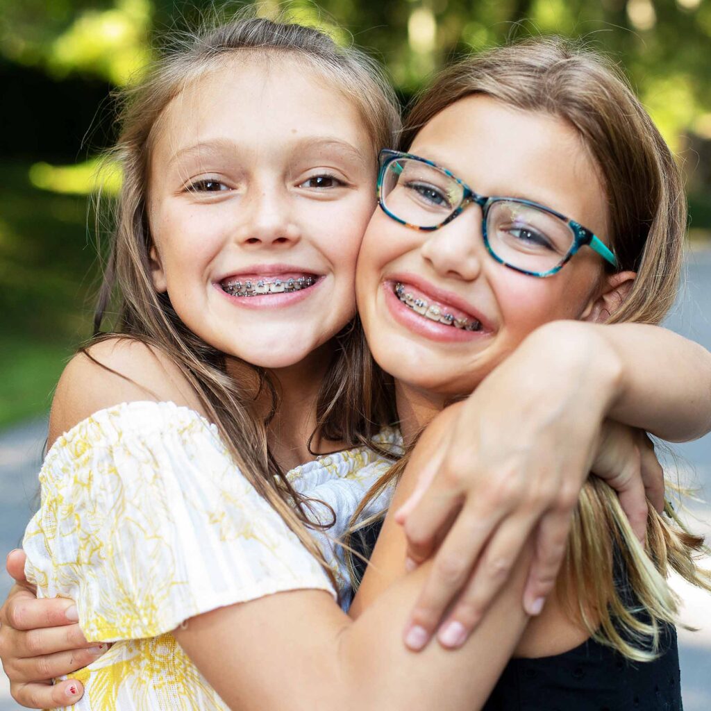 burckhard-ortho-hero-square-young-friends-hug-smiling